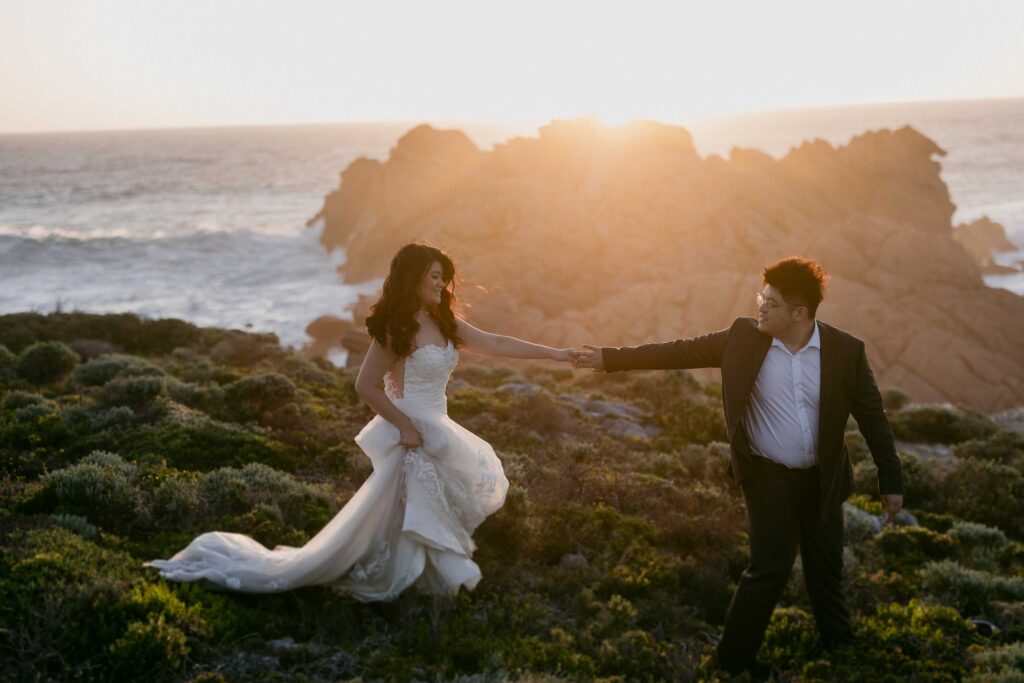 Cadence and Nicholas crossing the rocky coastline near Sugarloaf Rock