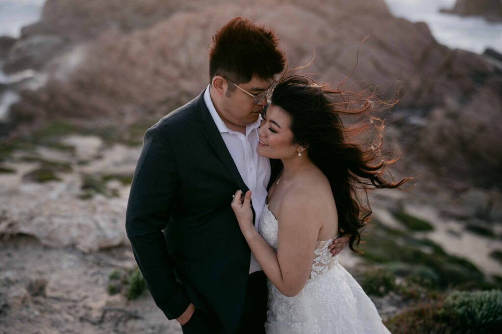 Windy coastal pre-wedding portrait at Sugarloaf Rock in Western Australia